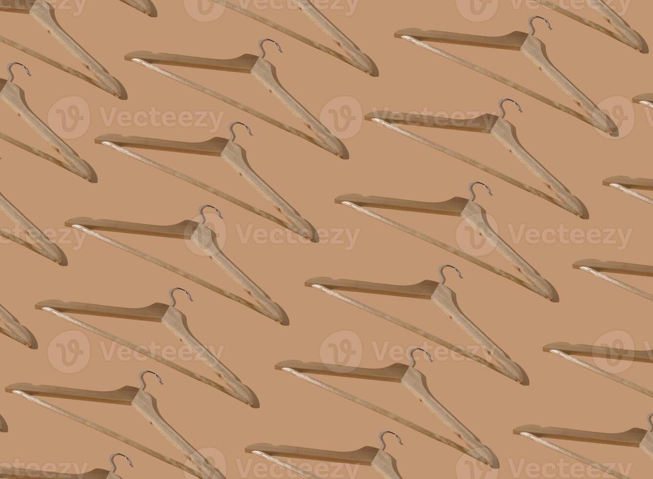 Pattern hangers for clothes. Hanger set. Beige background copy space banner. Wooden hangers. Store shop photo