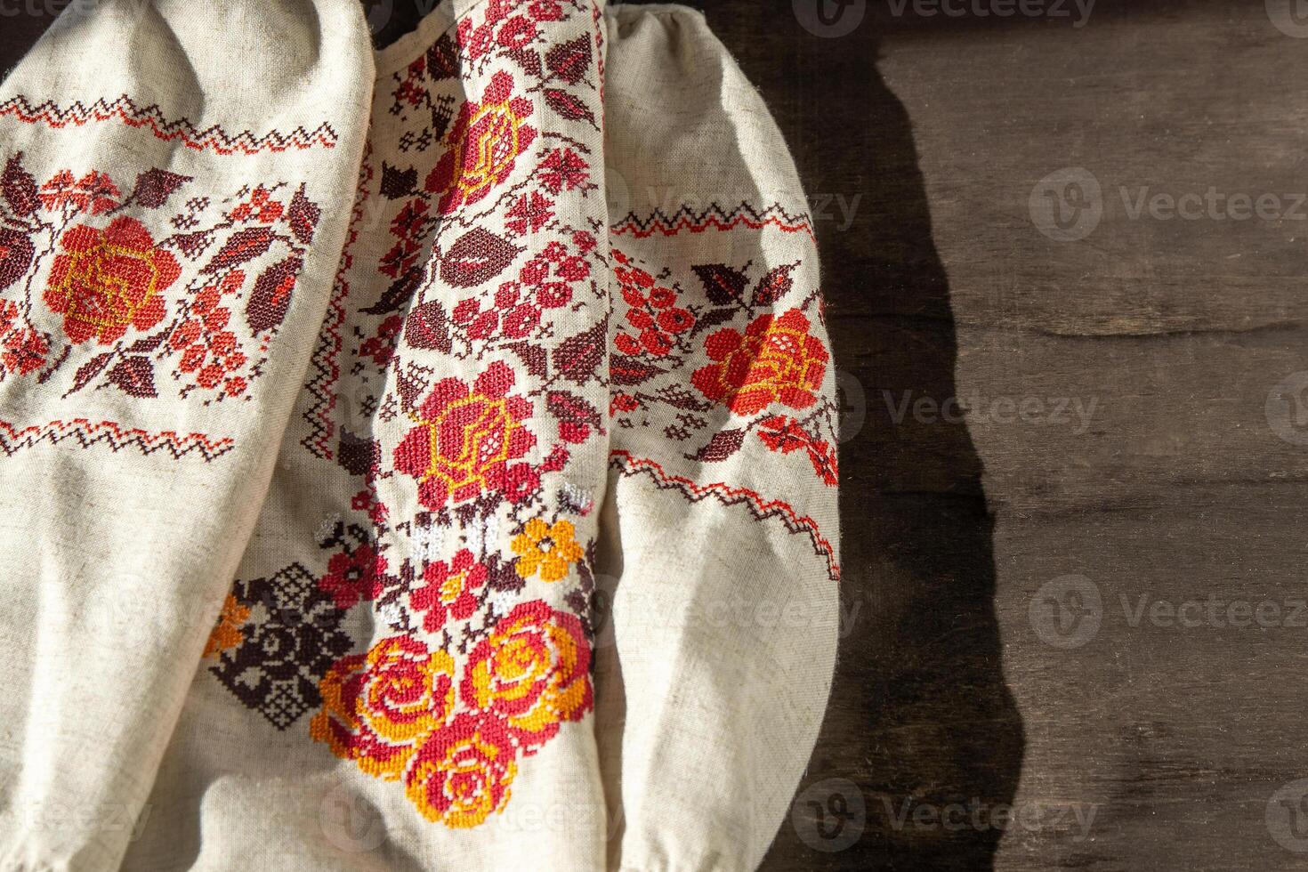 Ukrainian clothes embroidered shirt. Red orange and black threads background. Vyshyvanka is a symbol of Ukraine. Embroidery cross stitching. National Ukrainian stitch. Traditional clothing symbol photo