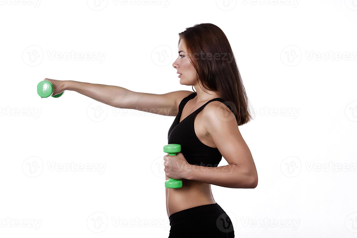 Fitness girl with dumbbells on a white background photo