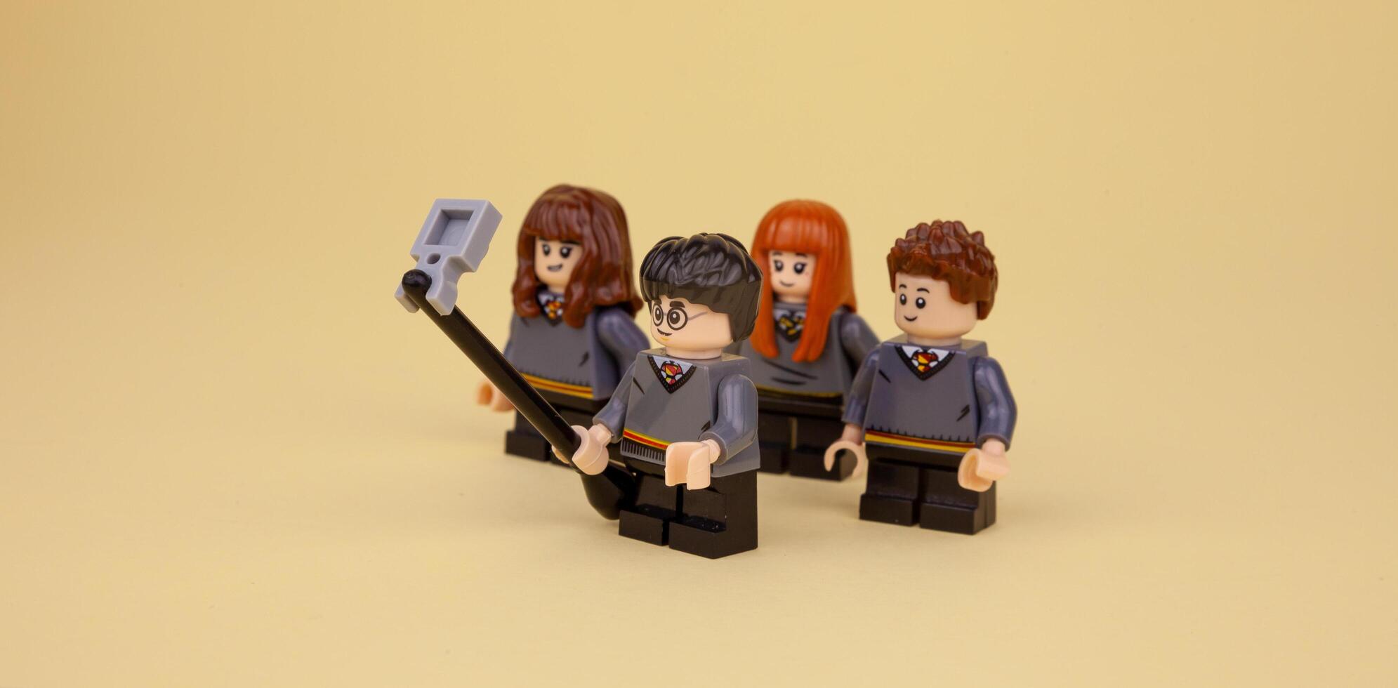 Kyiv, Ukraine - April 13, 2020 Lego men are photographed, take selfies. Harry Potter and friends. Meeting and photo as a keepsake. Blogging, direct phone and self-talk.