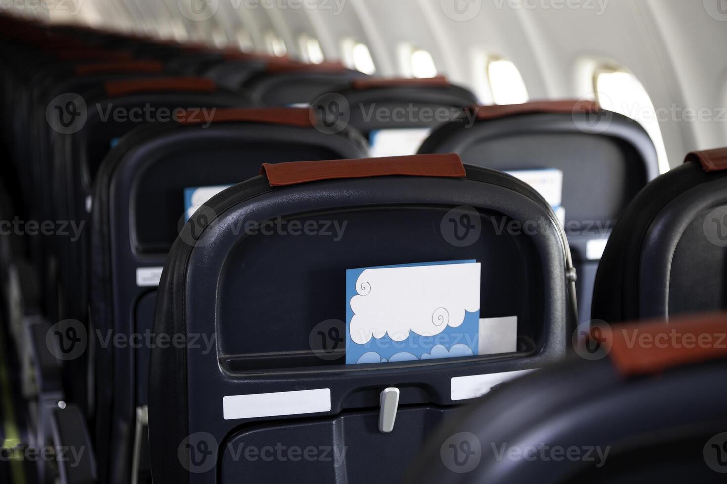 Airplane instruction, layout with place for text. Advertising brochure. Empty cabin of the plane. Soft seats for passengers, portholes. Inside a passenger plane. A seat on the plane. Copy space. photo