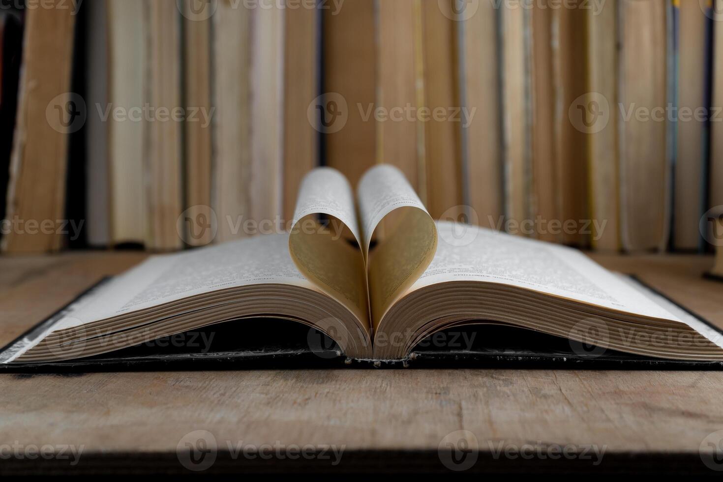 Heart shaped open book pages. Book background. Old books in the library. Bookshelf shop. Knowledge, publications, literature. Bookish, bookstore, bookshop photo