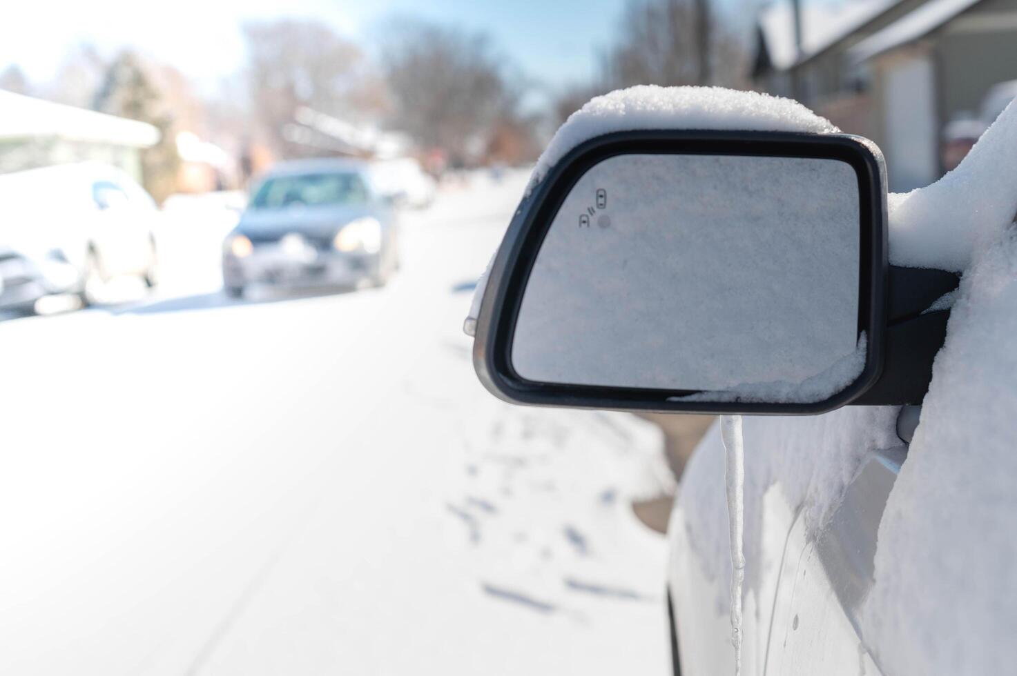 The white car is covered with pure white snow. At the winter time with snow strom. photo