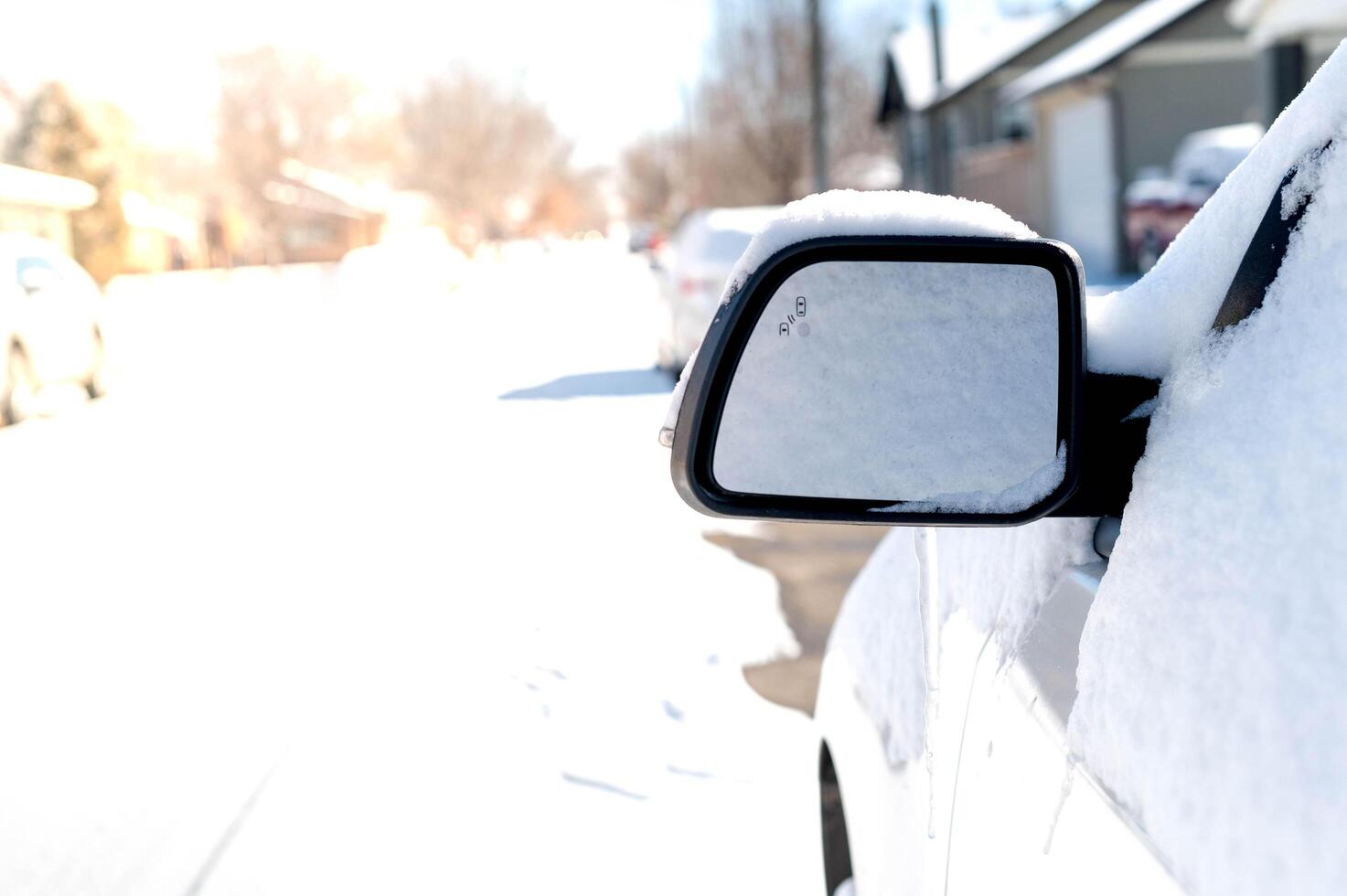 The white car is covered with pure white snow. At the winter time with snow strom. photo
