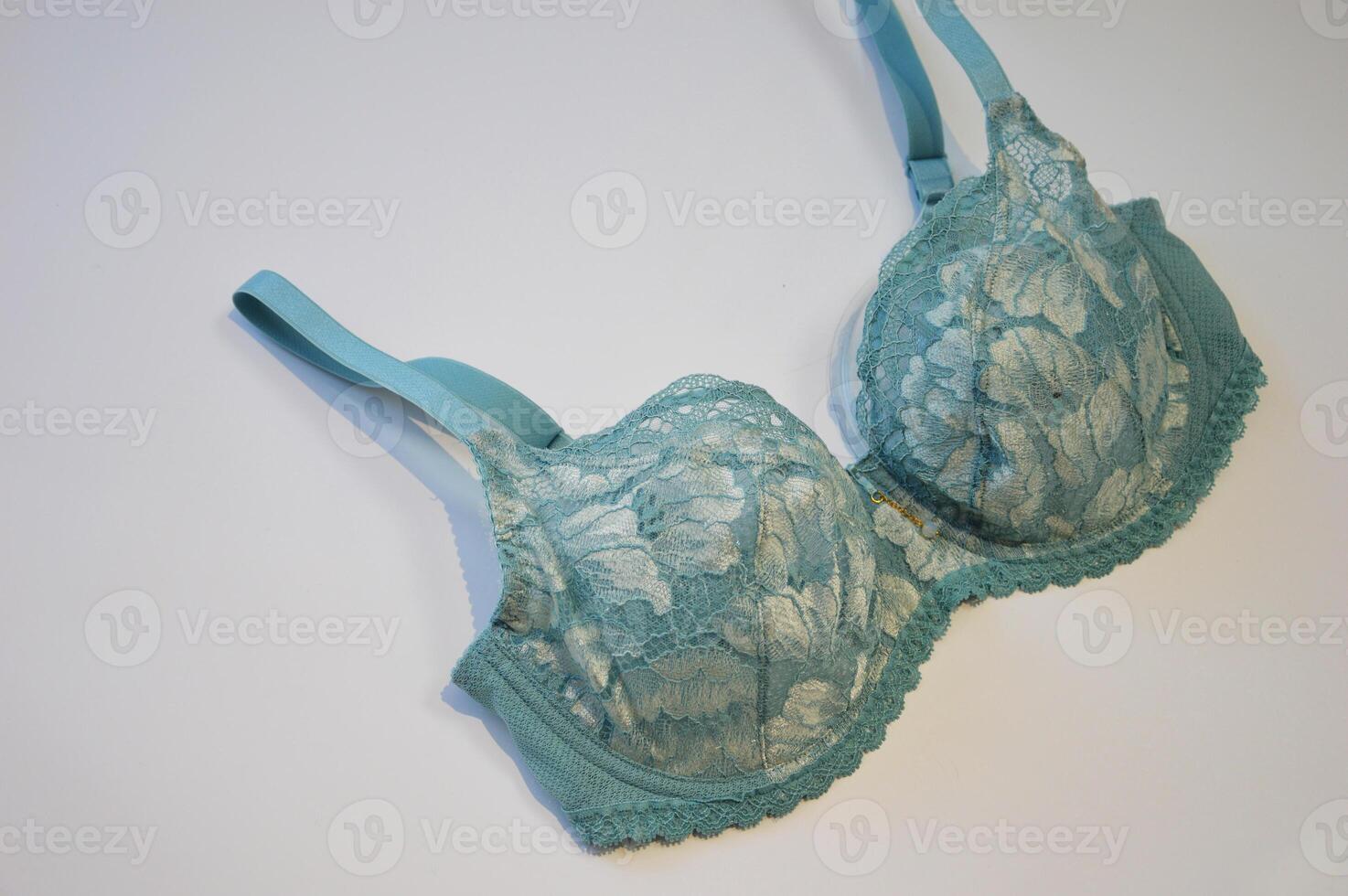 Lingerie. Stylish women's light blue lace bra on a white background. photo