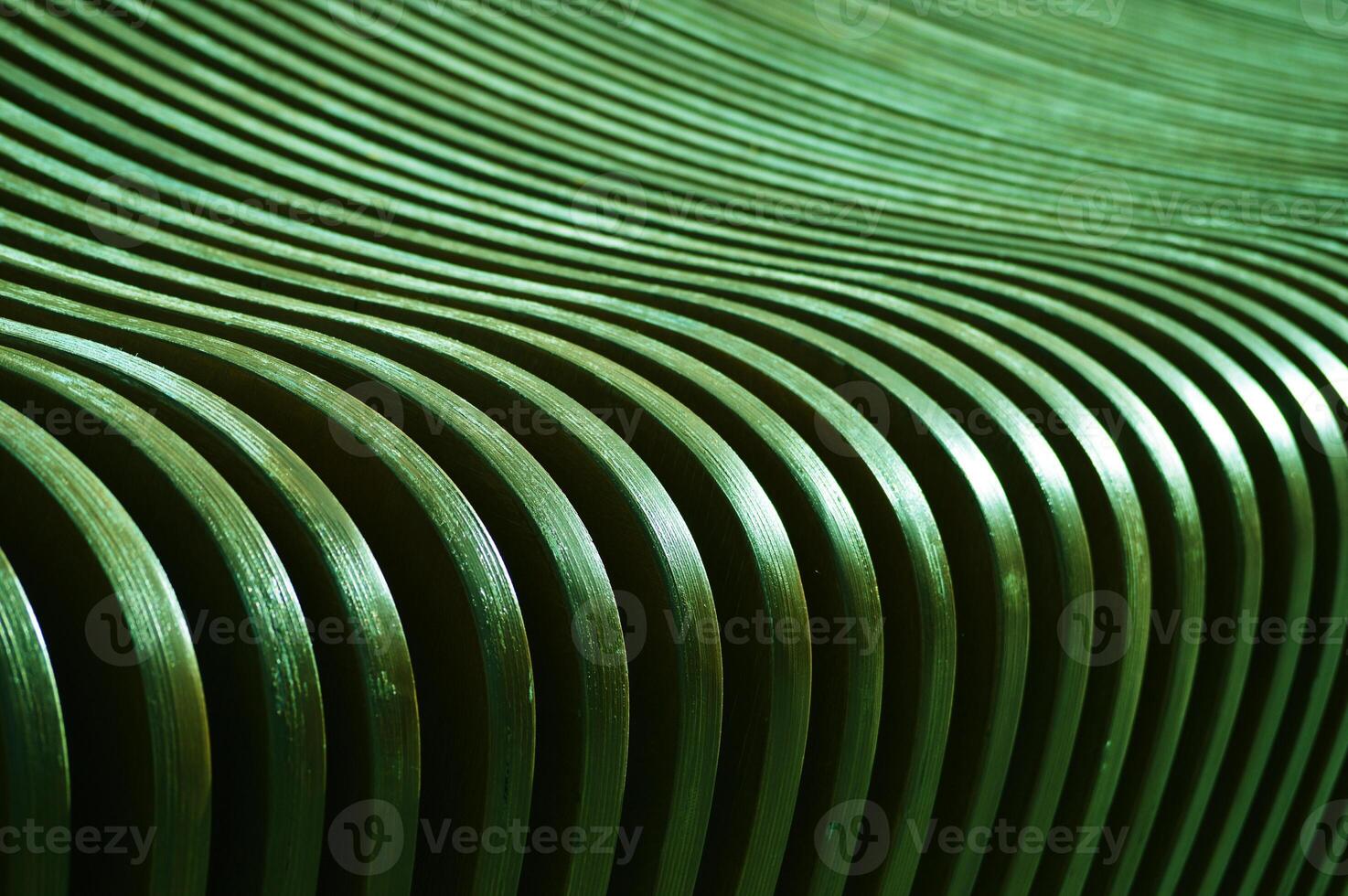 The surface of curved wooden planks, slats. Green boards changing angle and color. Abstract background. photo