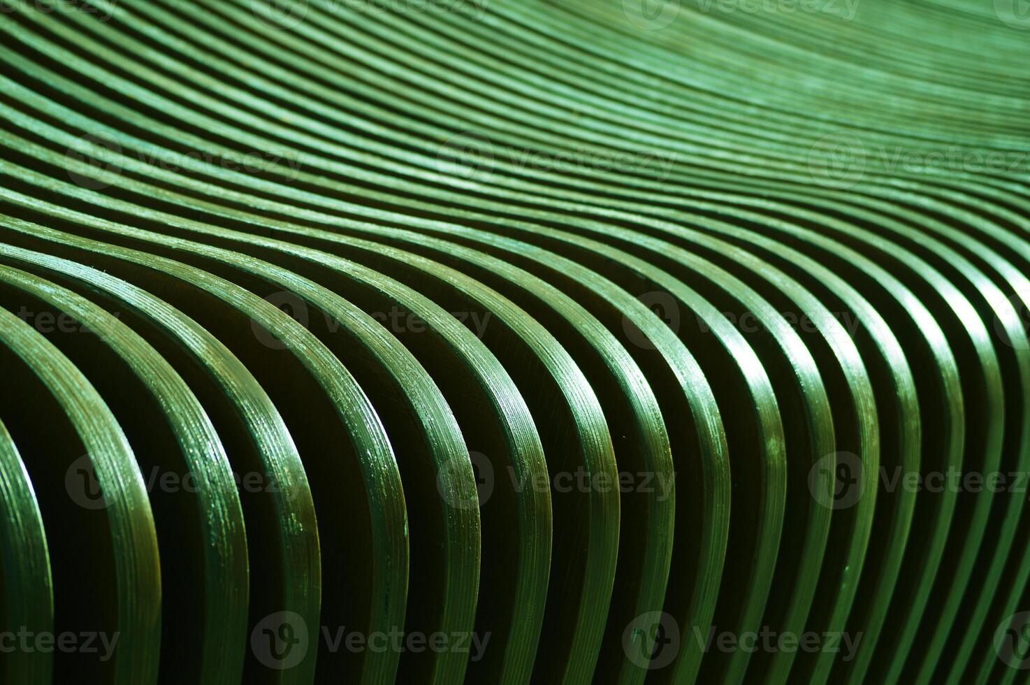 The surface of curved wooden planks, slats. Green boards changing angle and color. Abstract background. photo