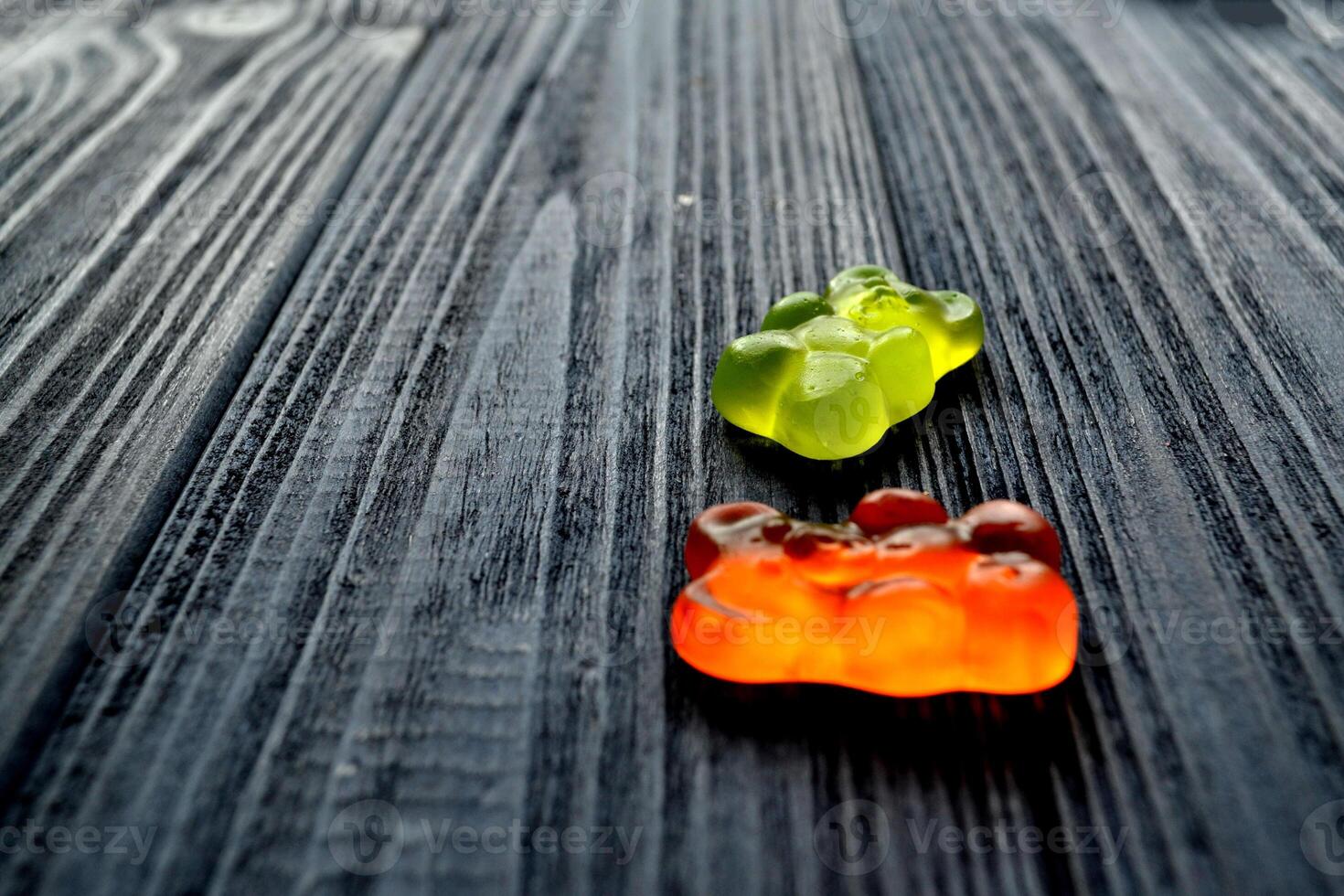 Jelly sweets on the dark blue wooden table. photo