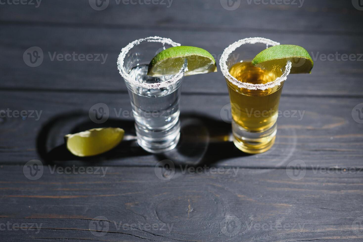 Mexican tequila with lime and salt on rustic wood background. space for text. concept luxury drink. Alcoholic drink concept. photo