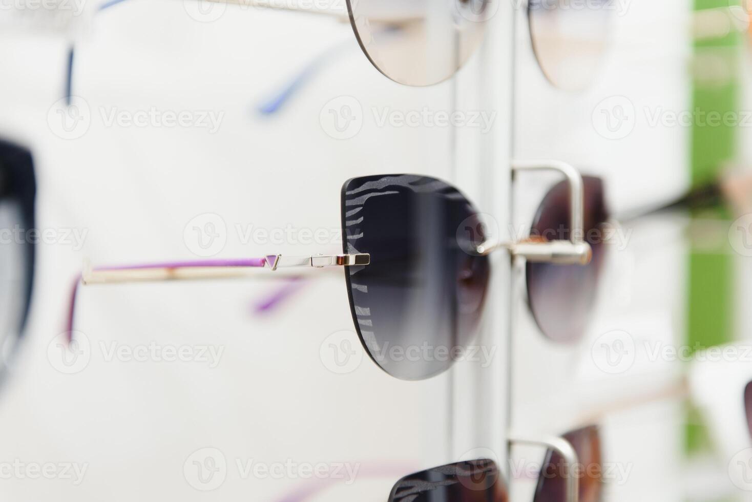 rack with glasses and sunglasses close up. photo