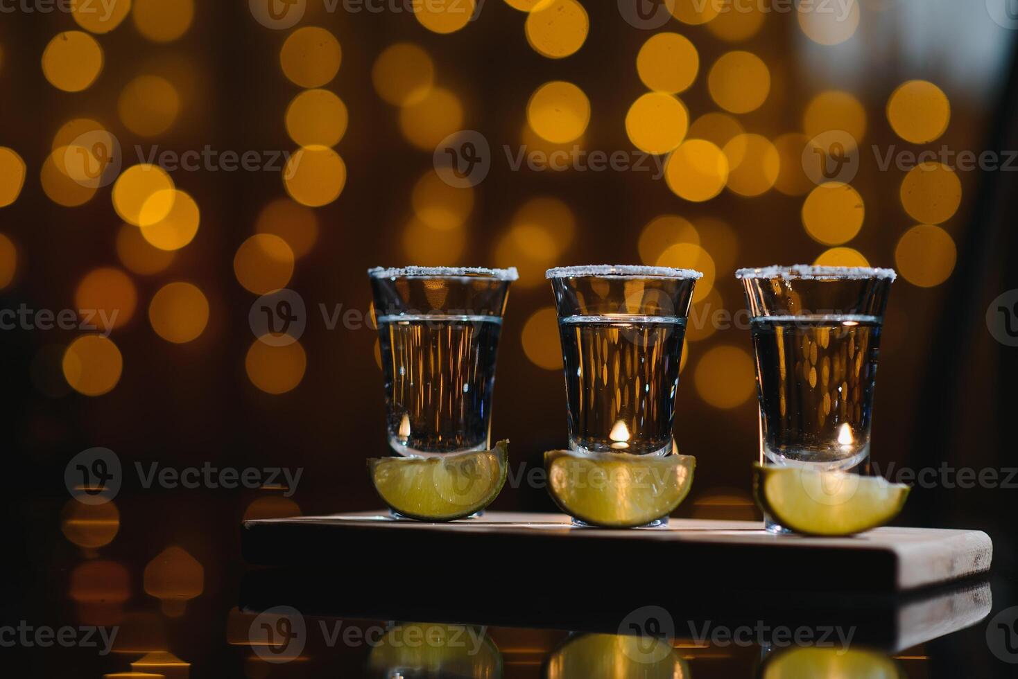 tequila with lime on a dark background photo