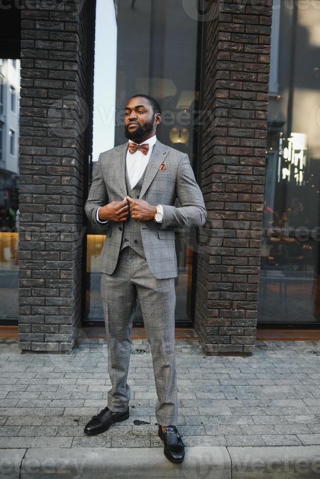 Portrait of an African American businessman wearing a suit standing in an outdoor business environment photo