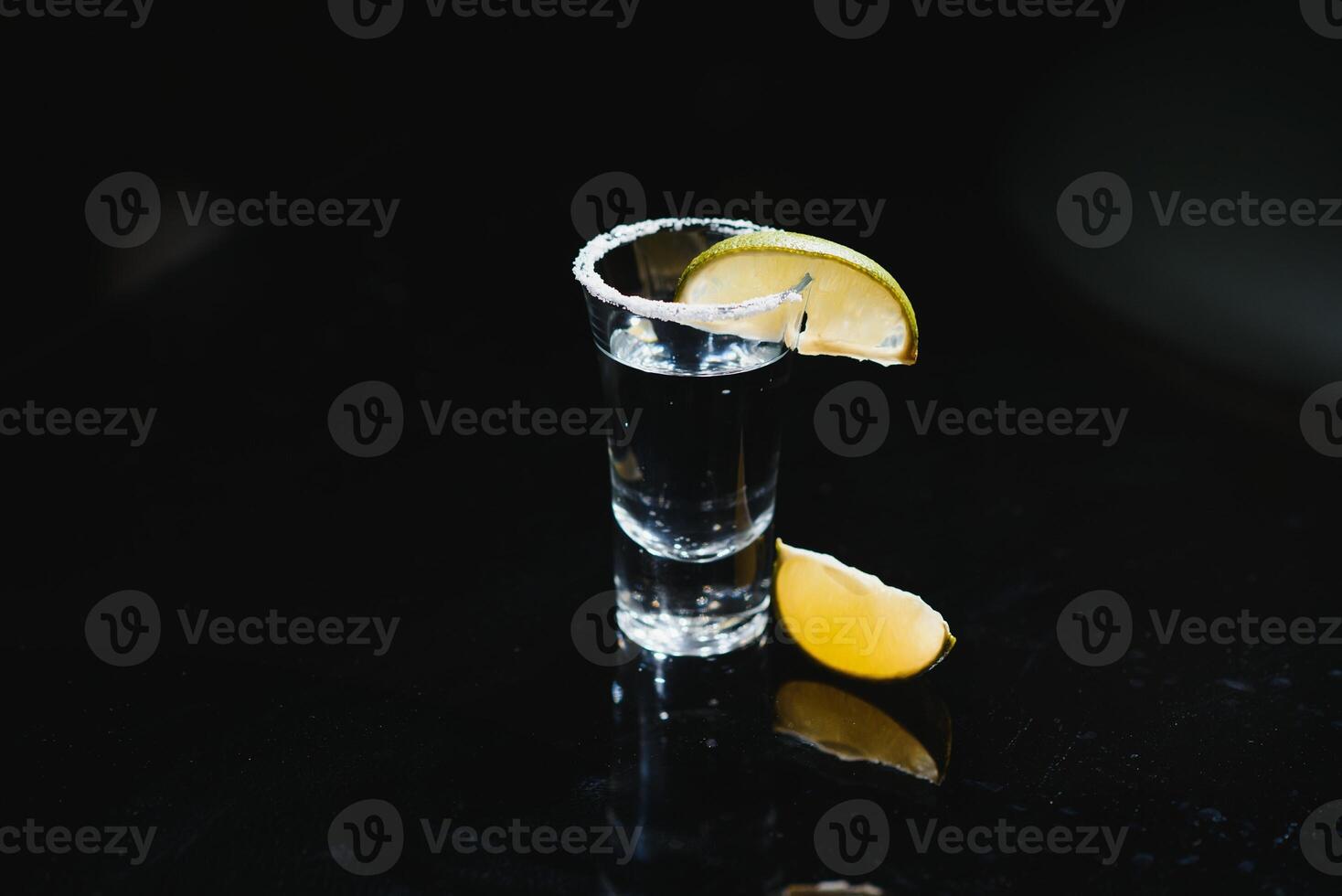 tequila with lime on a dark background photo