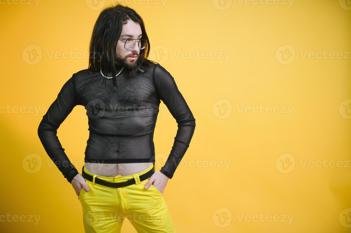 Young, handsome gay man on a colored background in the studio. LGBT concept. photo