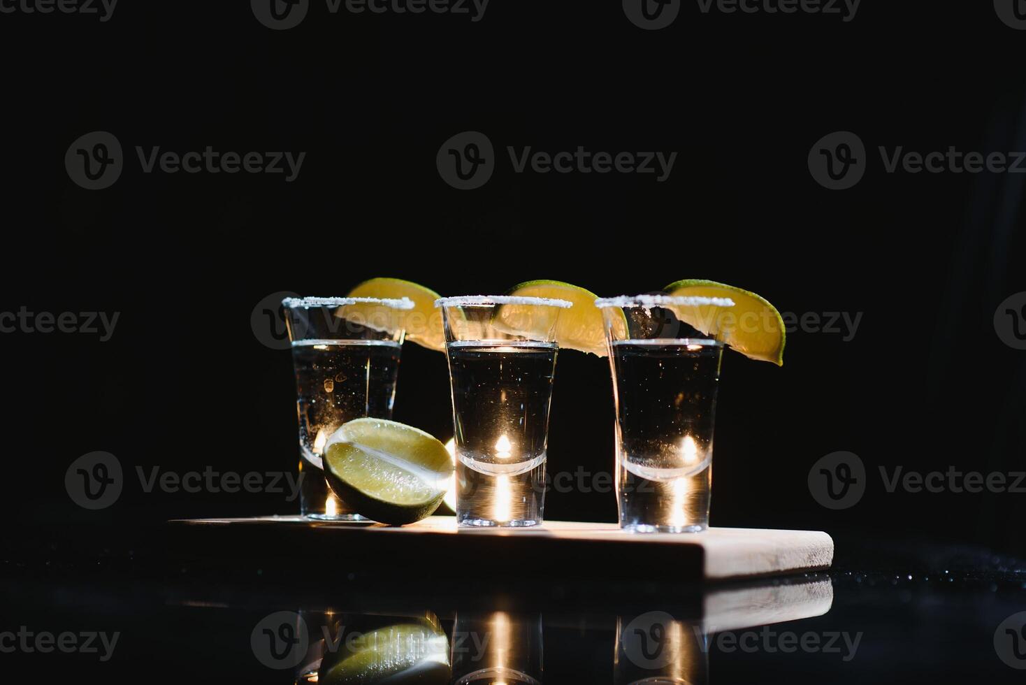 tequila with lime on a dark background photo