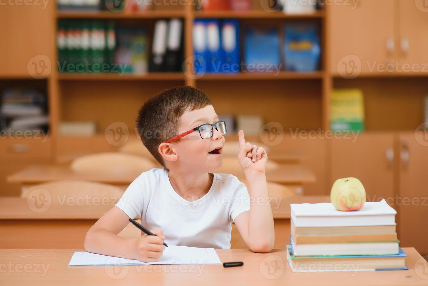 School boy in classroom at lesson photo