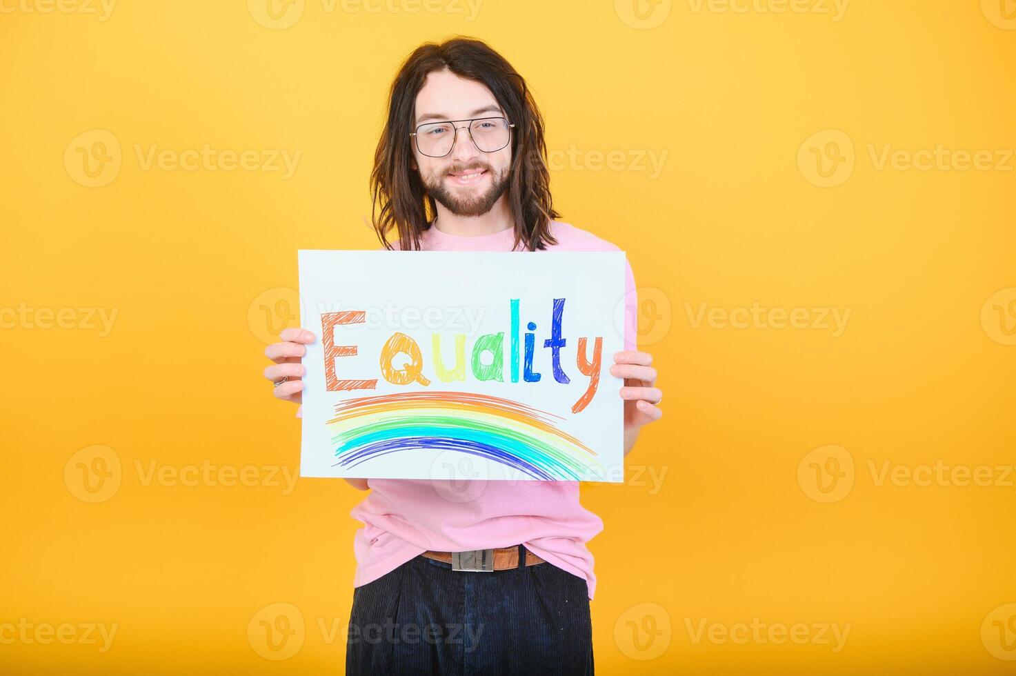 Hands of gay man holding lgbt banner on rainbow flag background lgbt symbol photo