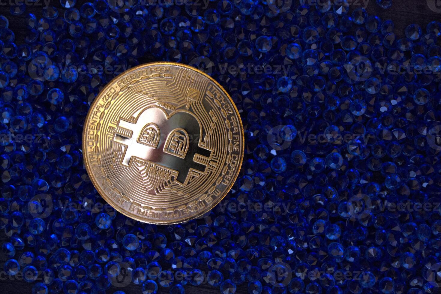 Golden bitcoin on the blue jewels. photo