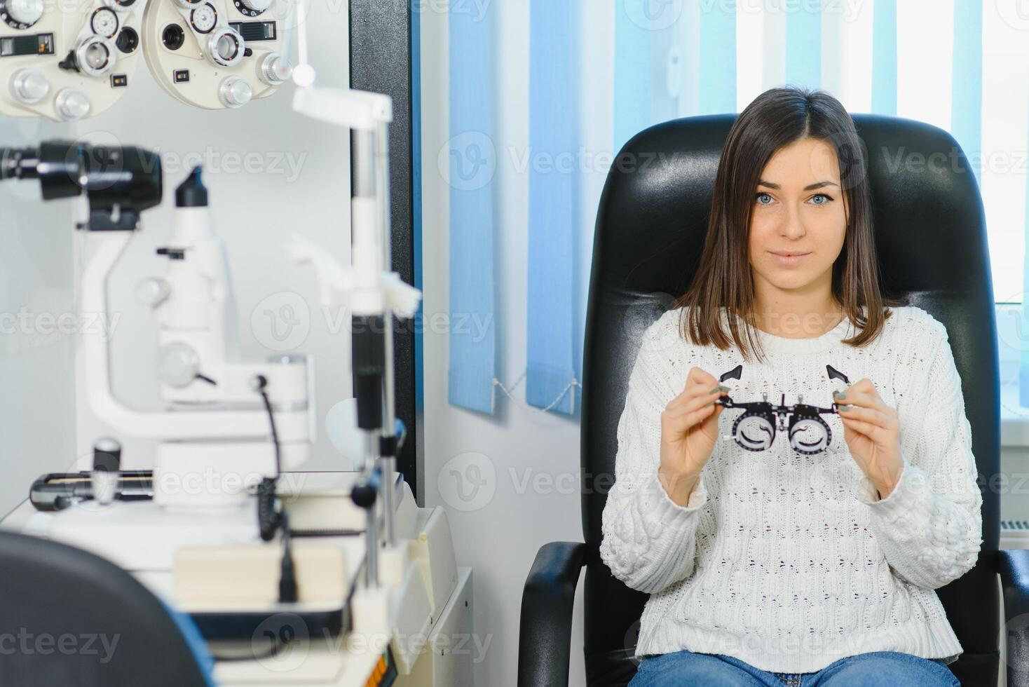 Selection of glasses for sight for the woman. The correct selection of points. Optical Salon. Optician. Trial lenses photo