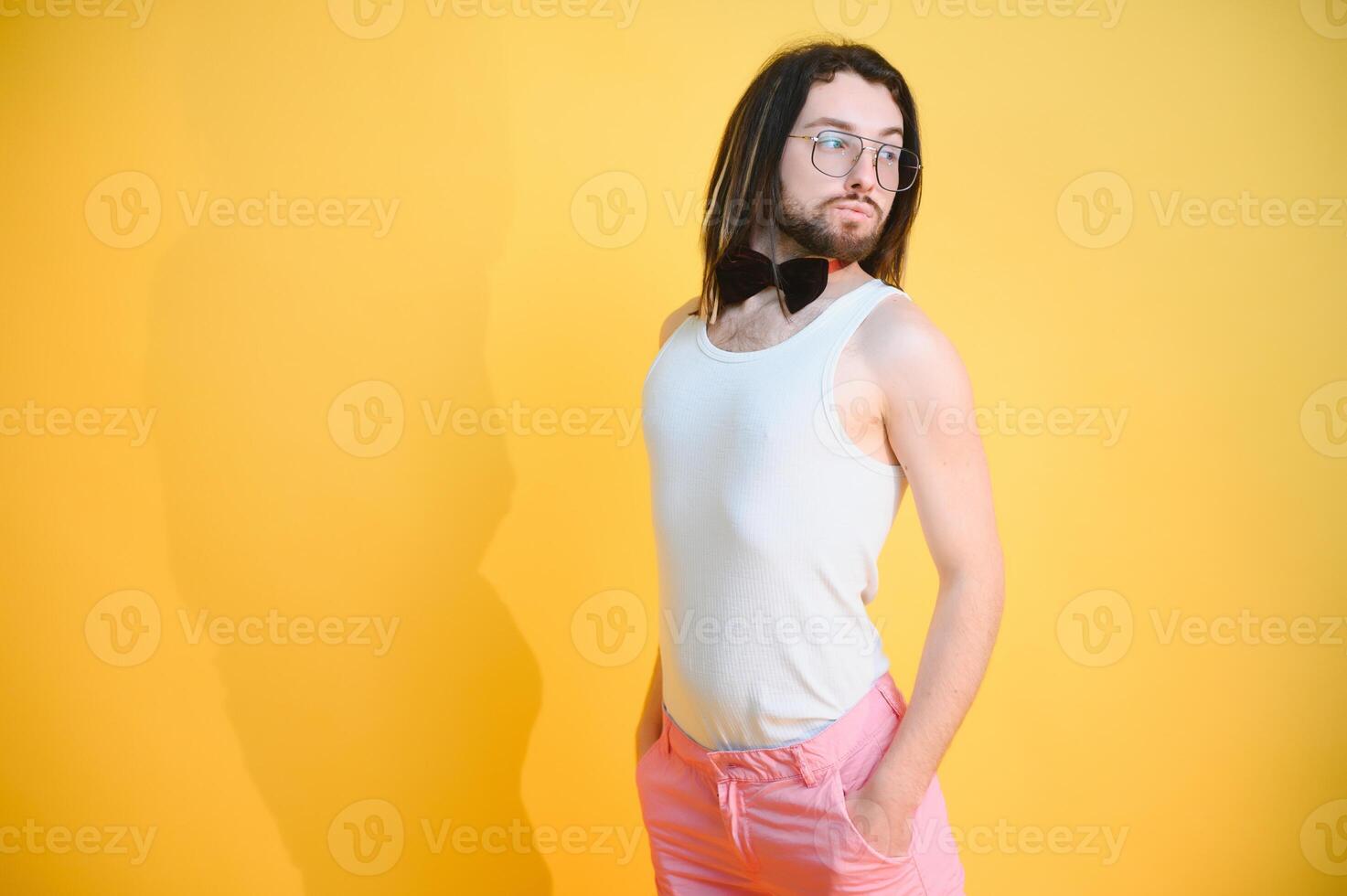 Young, handsome gay man on a colored background in the studio. LGBT concept. photo