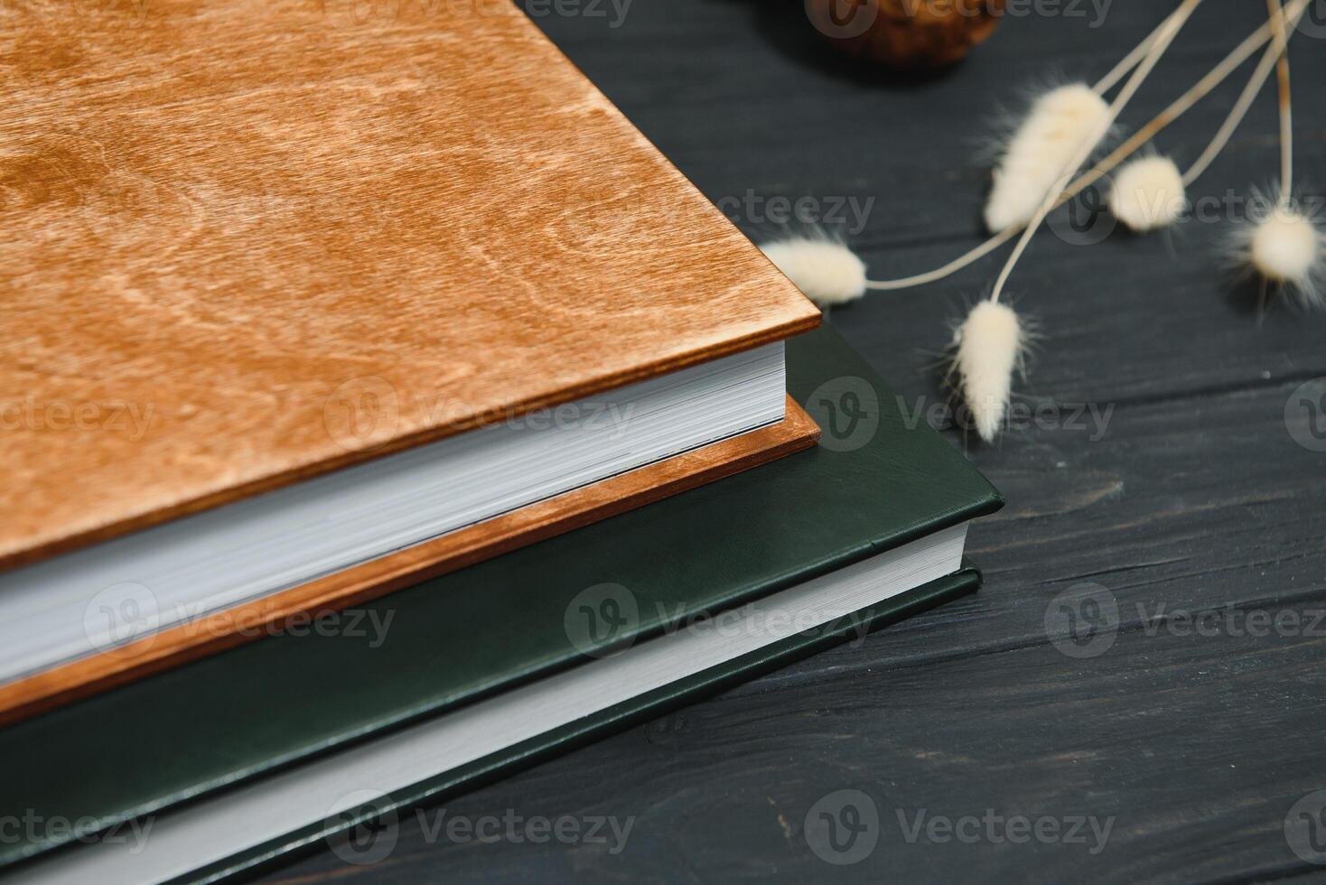 Green wedding or family photo book with leather cover. stylish wedding photo album close up. family photoalbum on wooden background.