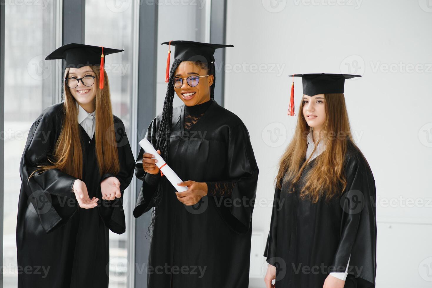 portrait of multiracial graduates holding diploma photo