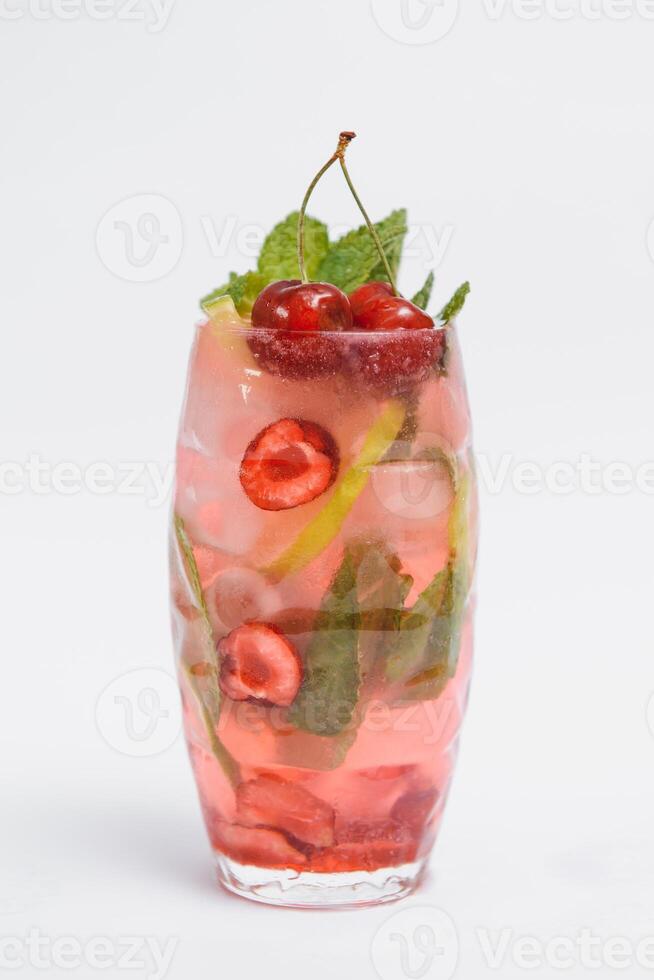 Glasse Of Drink With Ice Cubes And Fruits On White Background photo