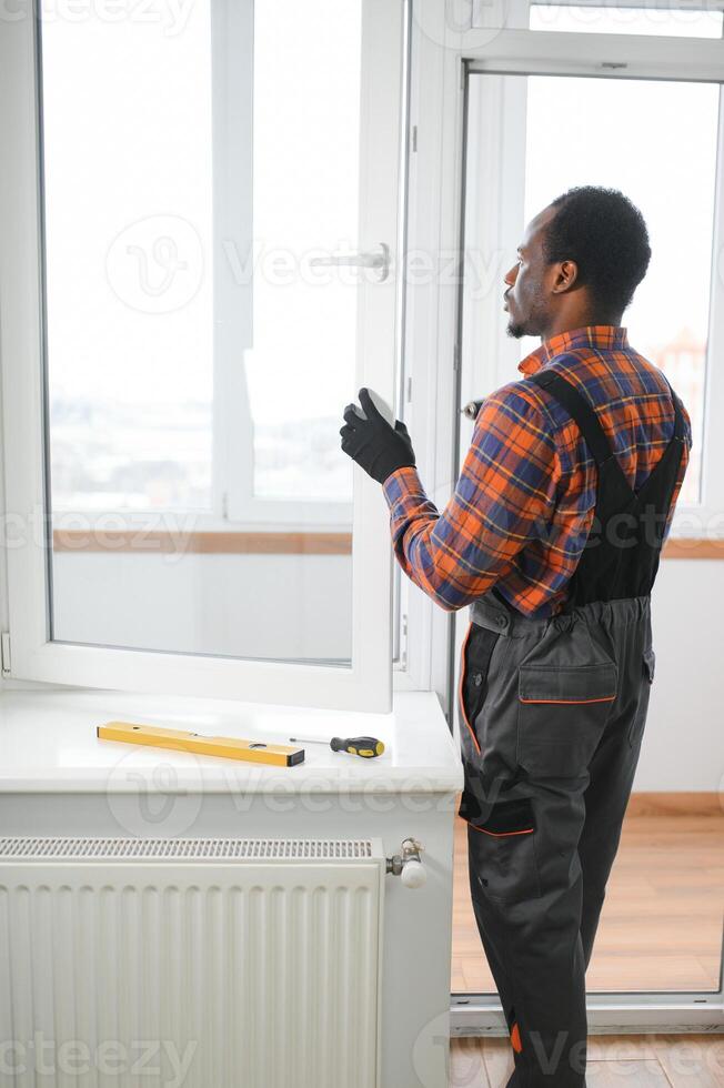 African service man installing window photo