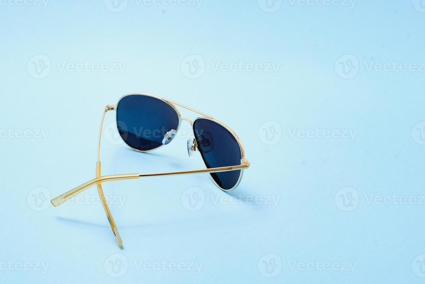 Beautiful trendly sunglasses on a Classic Blue Pantone color of the year background photo