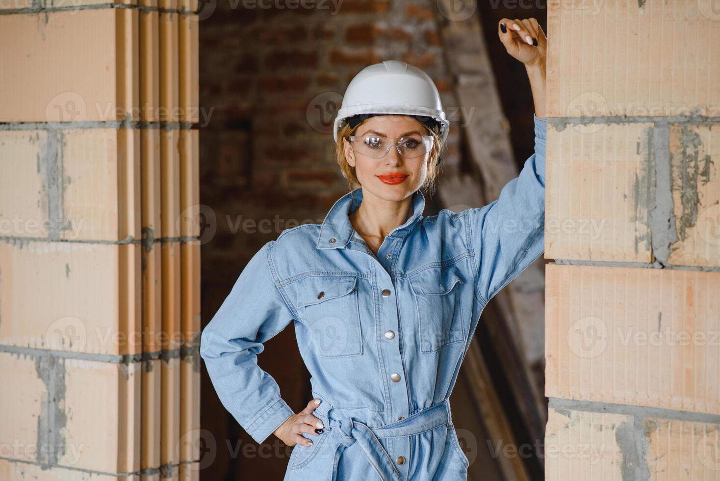 Warehouse woman worker. Woman builder in hardhat. Girl engineer or architect. Home renovation. Quality inspector. Construction job occupation. Construction worker. Lady at construction site photo