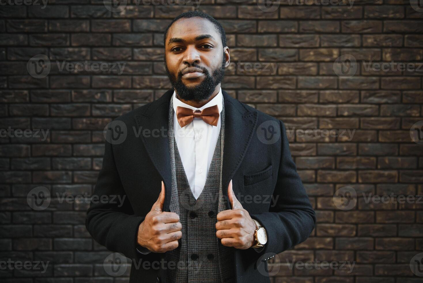 Fashion portrait of a handsome young African American business man walking outdoors in a casual pose. photo