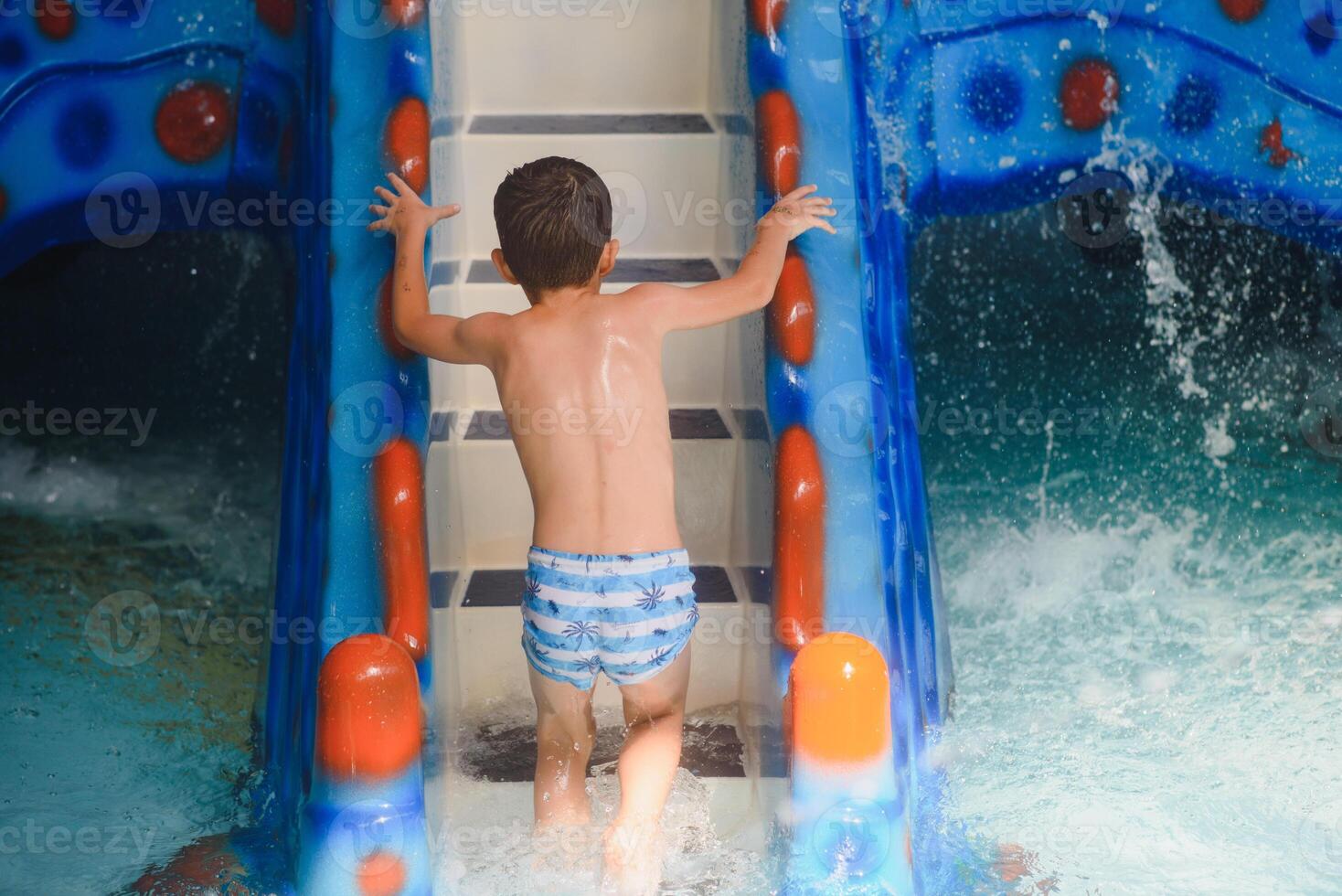 Boy having fun in aqua park photo