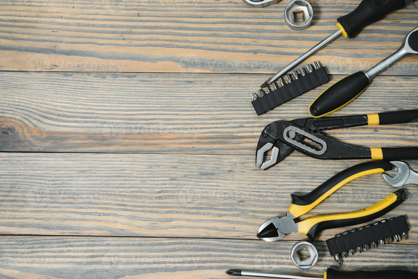 Different construction tools on a wooden background with copy space photo