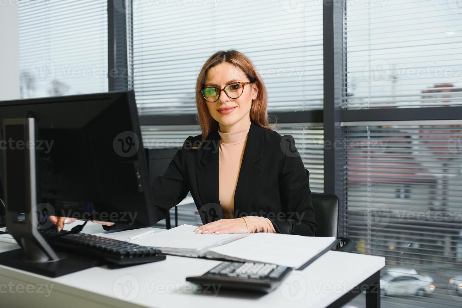 Portrait of smiling modern business woman in office photo