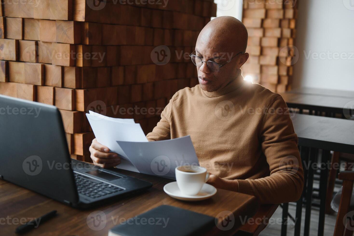 African american business man with laptop in a cafe. photo