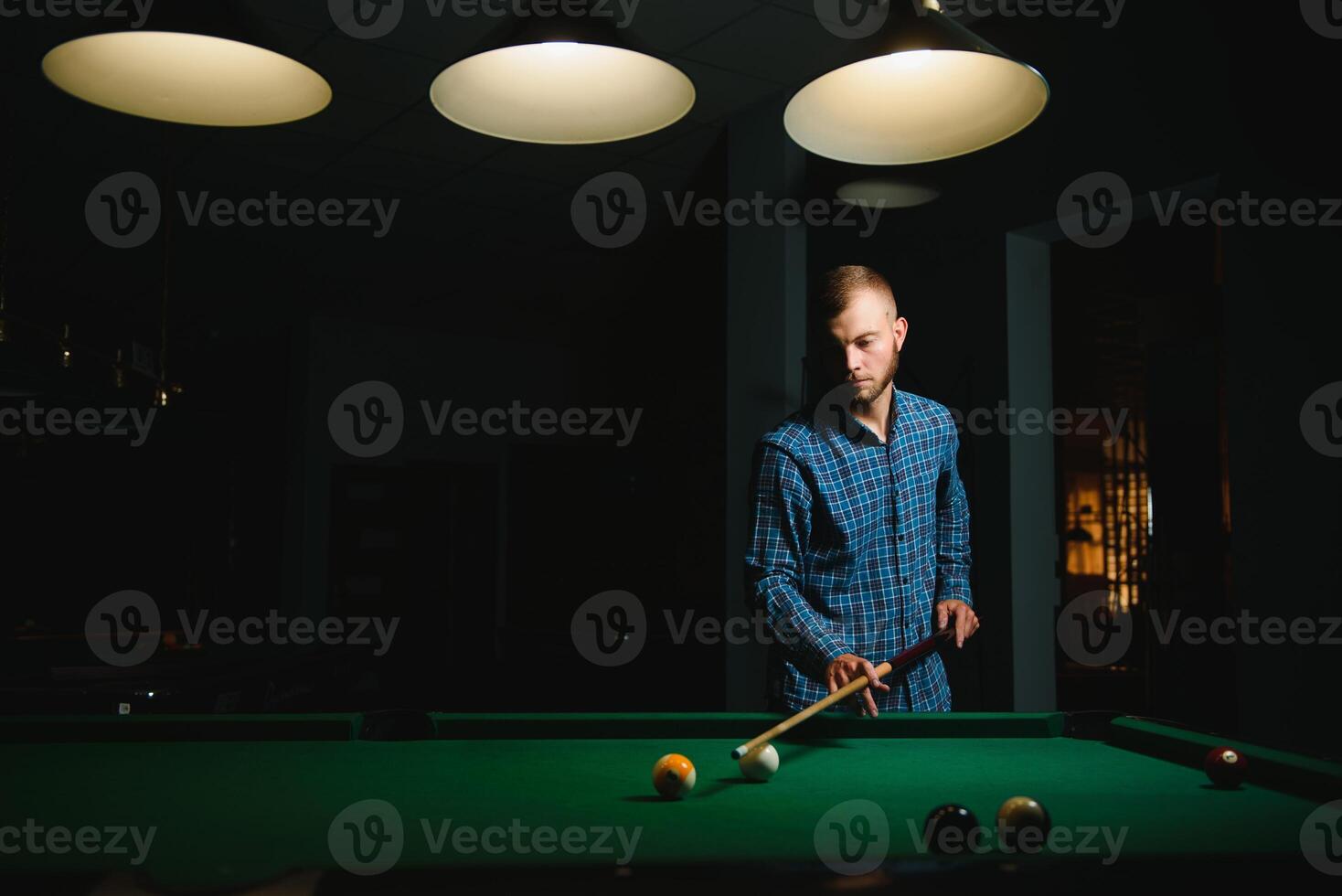 Playing billiard - Close-up shot of a man playing billiard photo