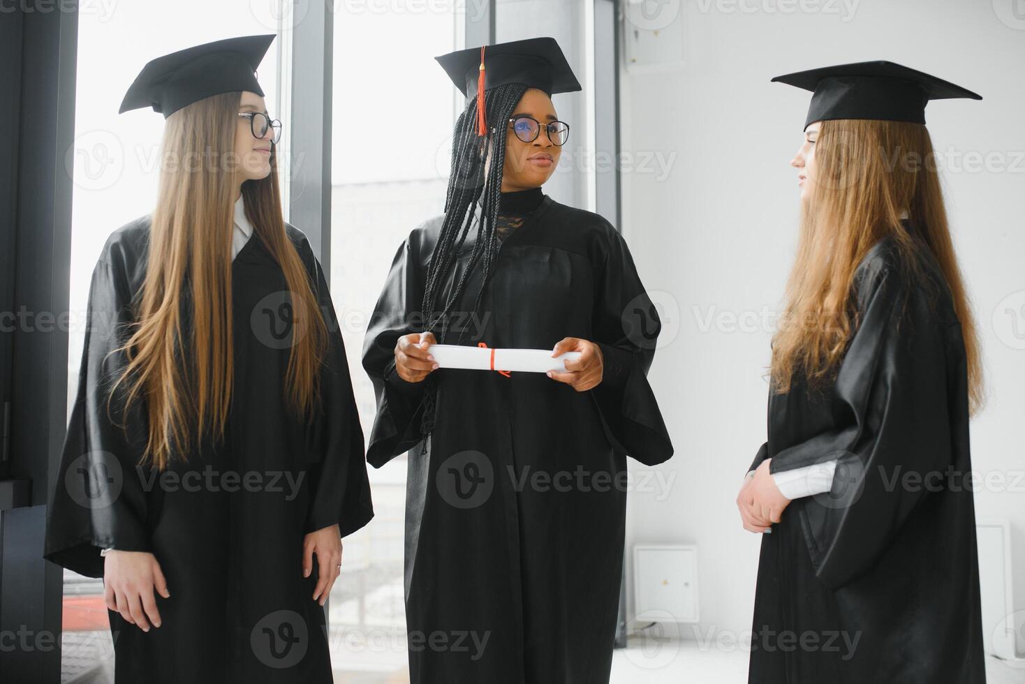 portrait of multiracial graduates holding diploma photo