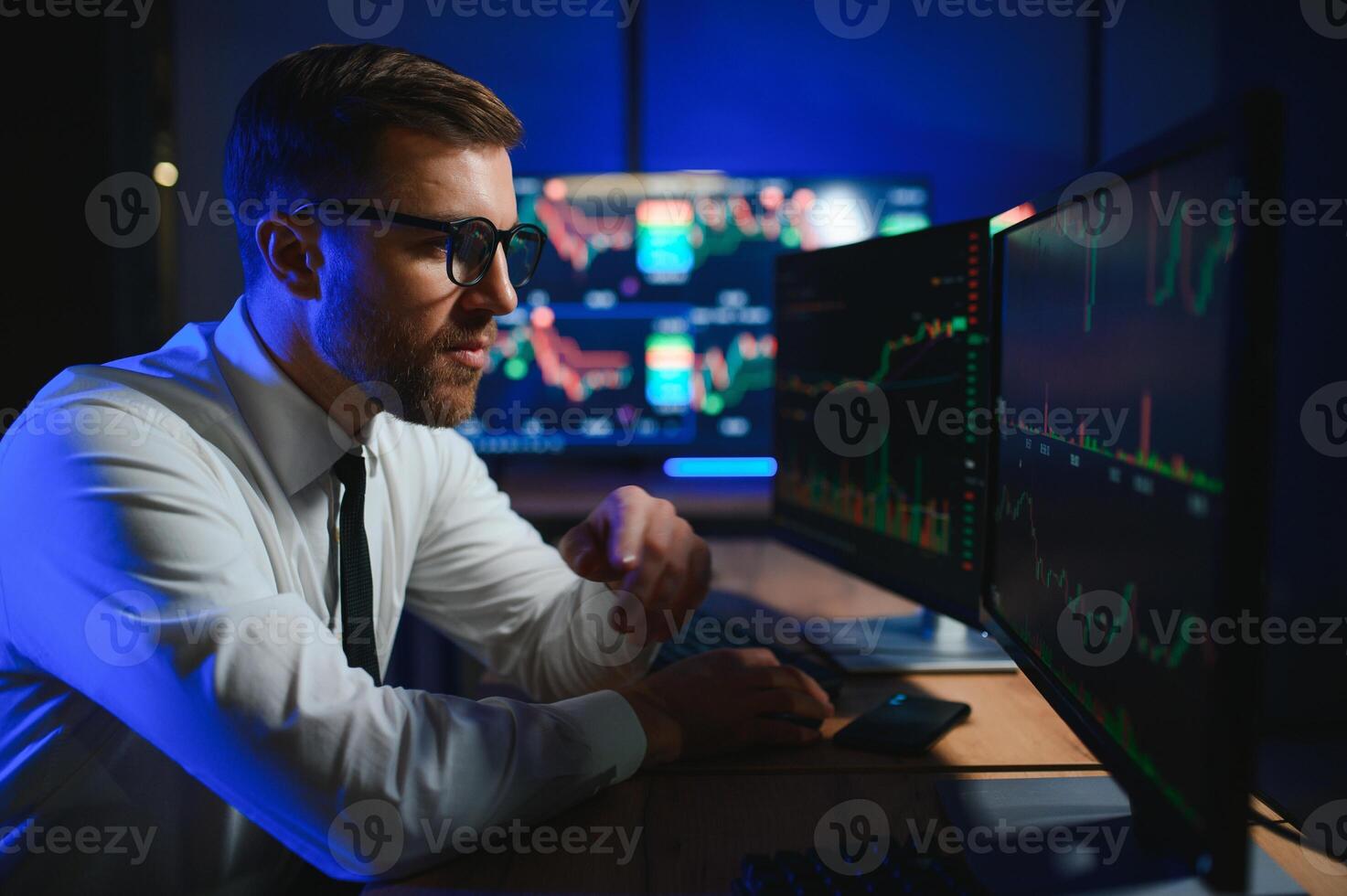 Financial Analyst. Businessman Works in Investment Bank Downtown Office at Night photo