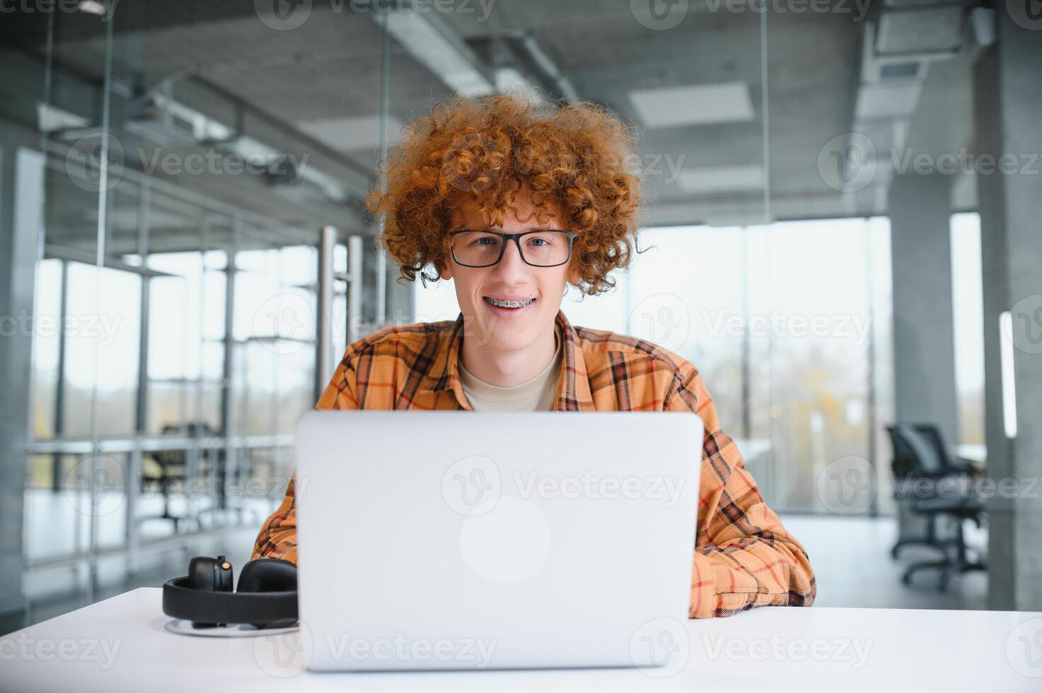 masculino programador vestir gafas para ojos proteccion mientras trabajando en Lanza libre vía ordenador portátil computadora, inteligente estudiante acecho tutorial en netbook foto