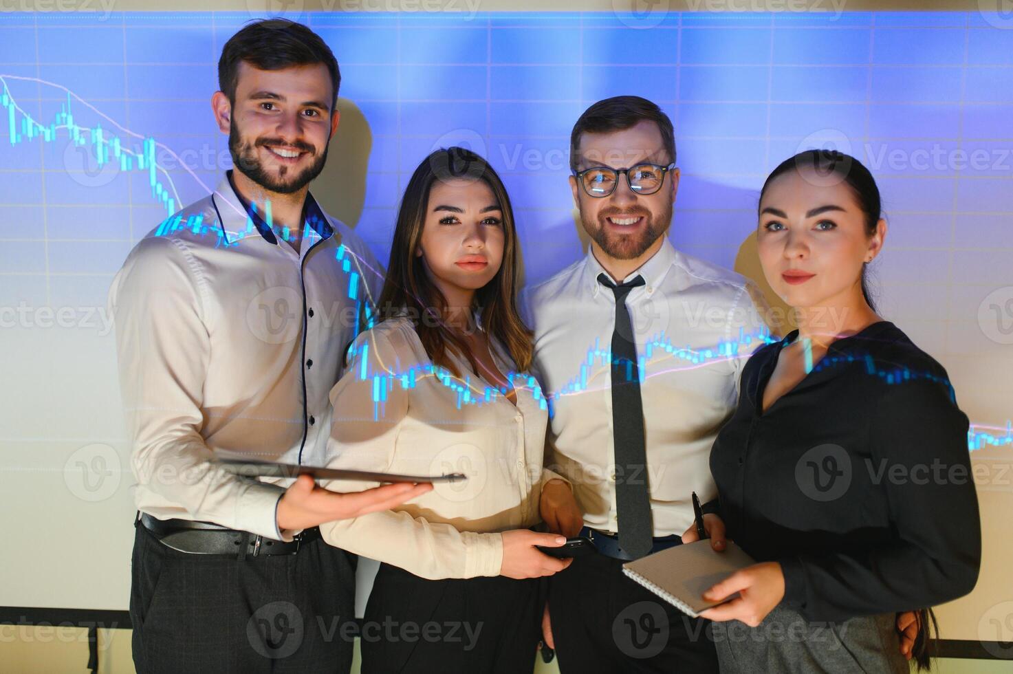 Group of business people working at modern office.Technical price graph, red and blue candlestick chart and stock trading computer screen background. Double exposure. Traders analyzing data photo