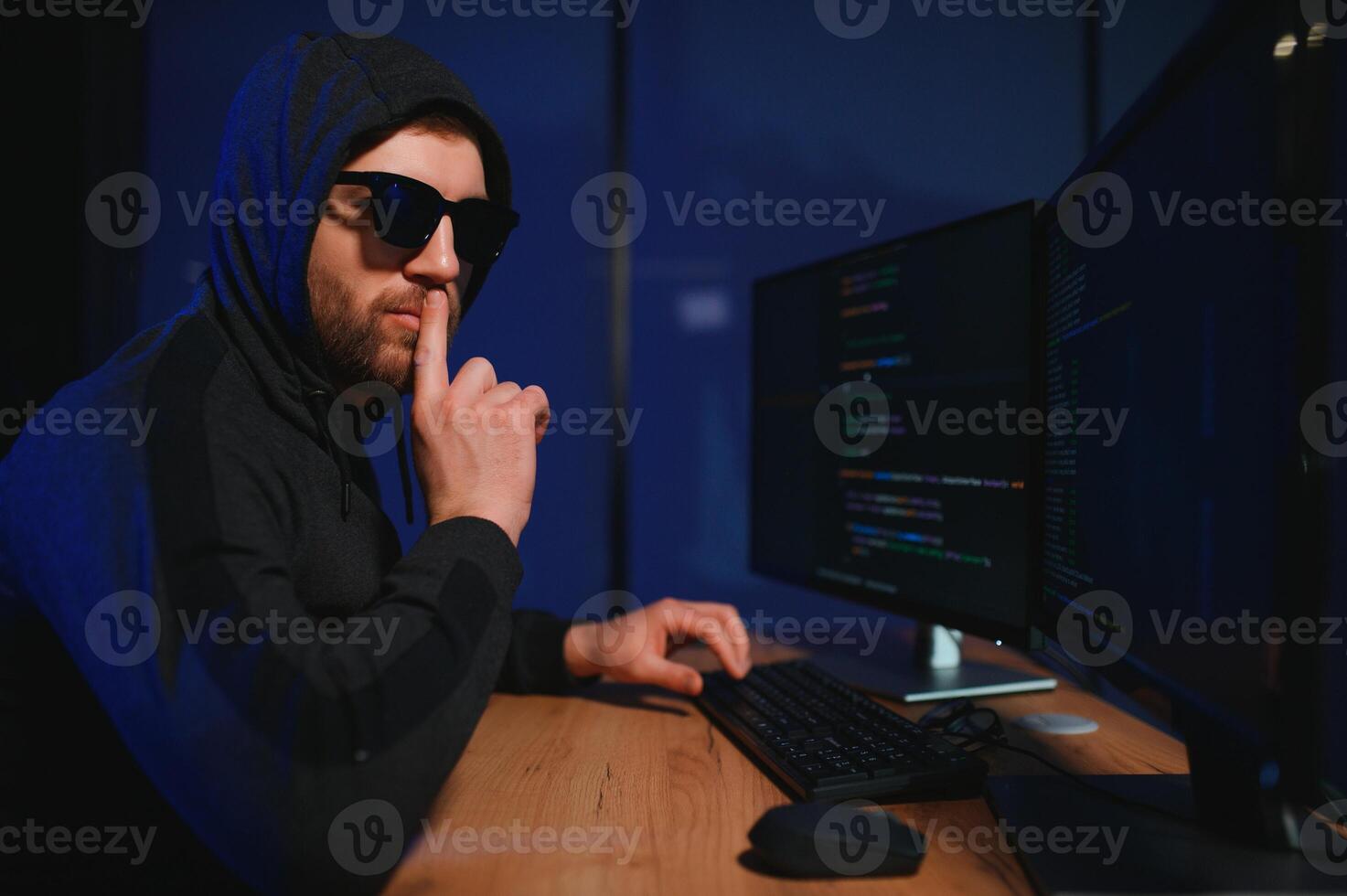 Hacker is hacking into the computer network. Computer criminal photo