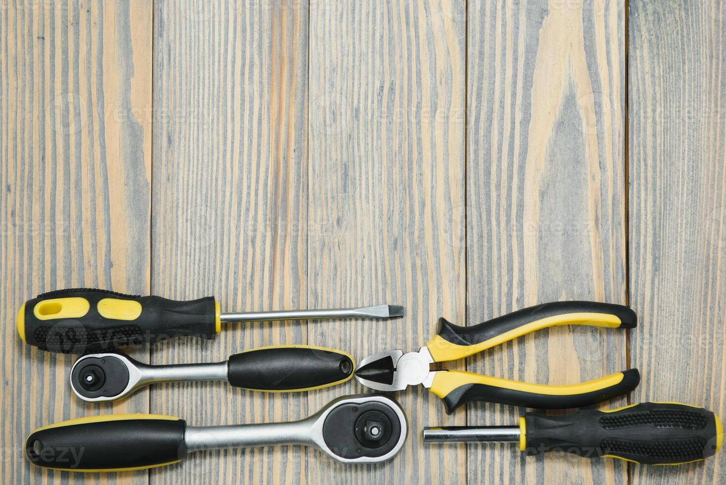 Set of tools over a wood panel with space for text photo