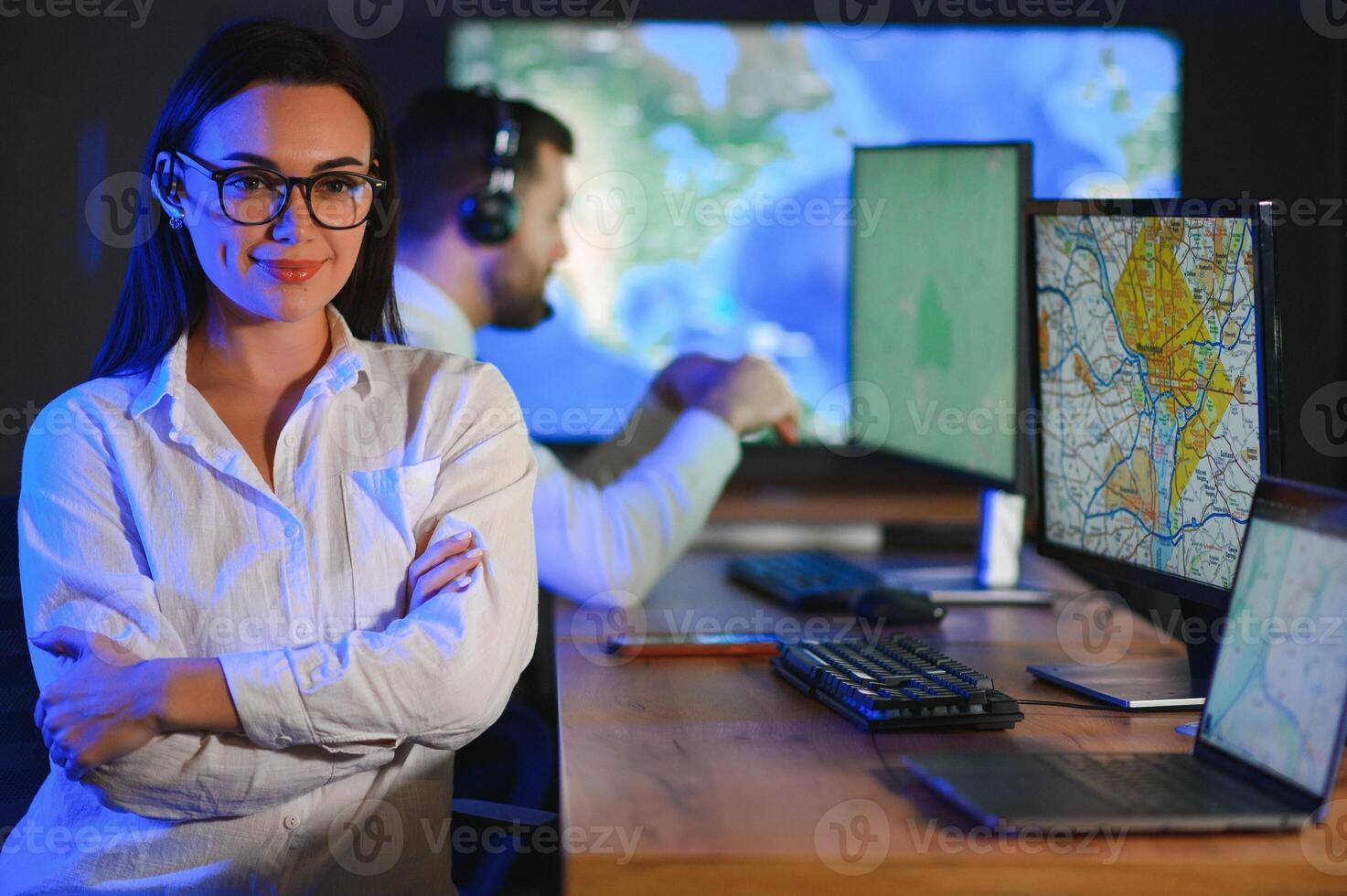 Smiling friendly female call center agent with headset working on support hotline in the office photo