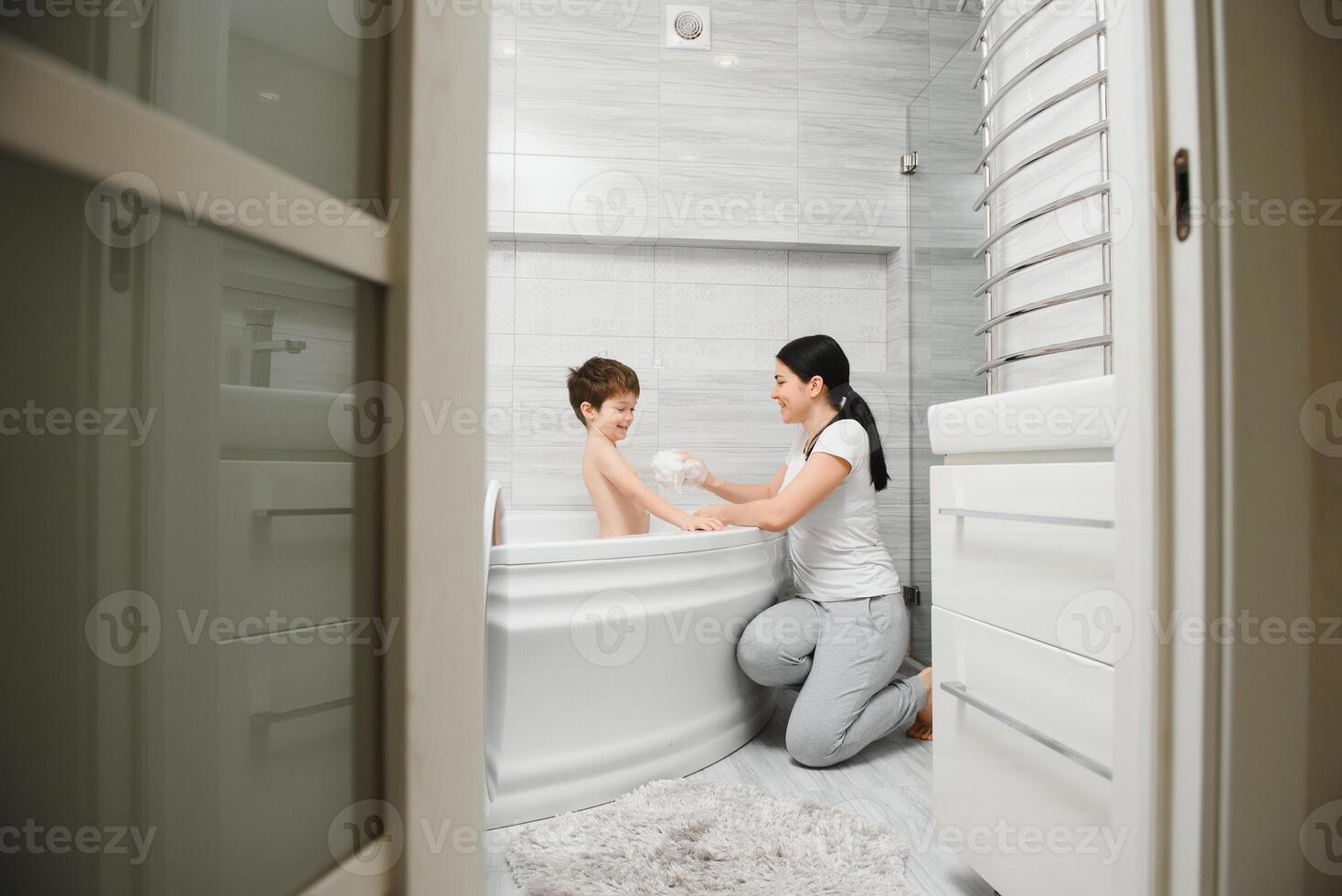 Mother And Son Having Fun At Bath Time Together photo