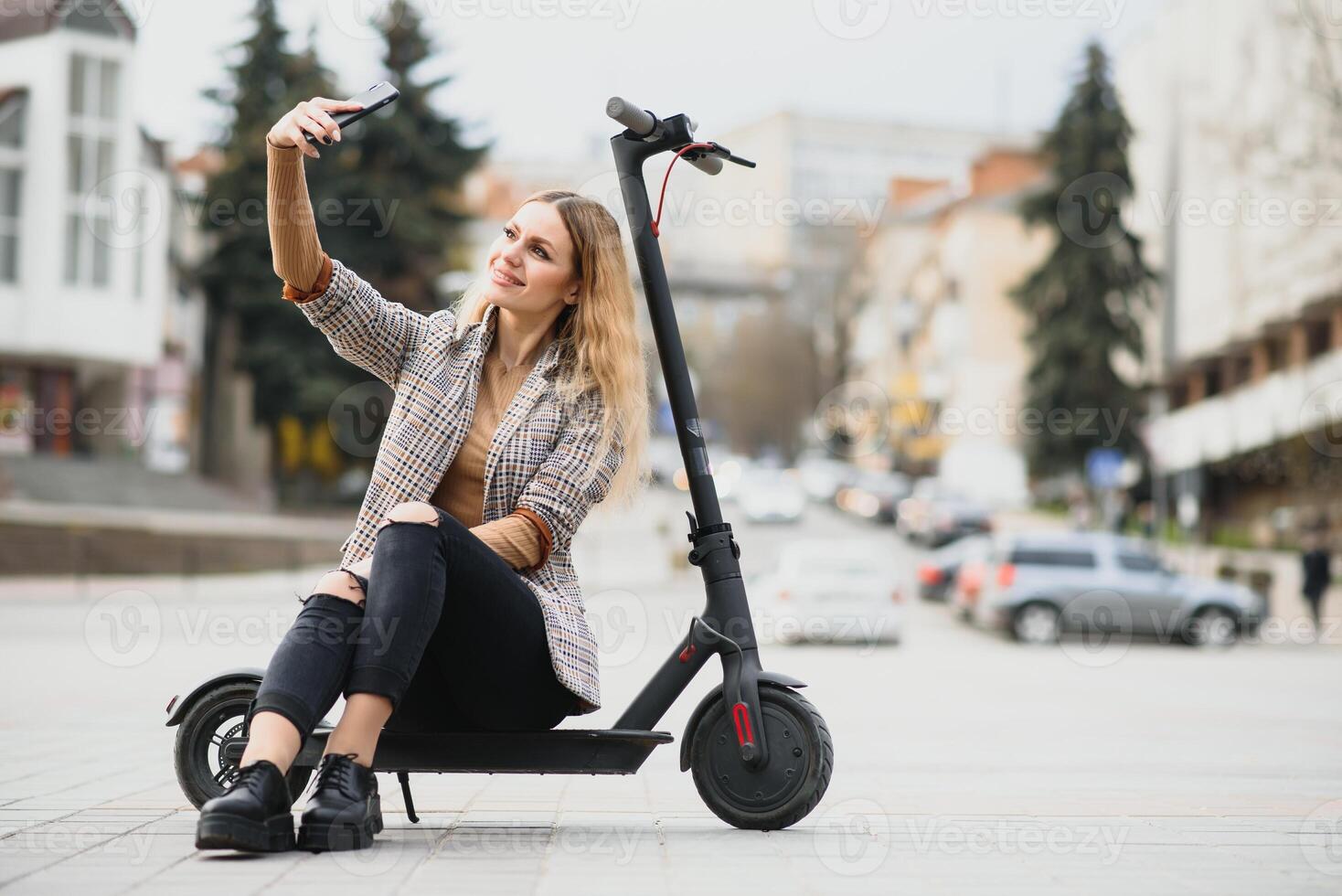 Young woman on electro scooter in city. photo