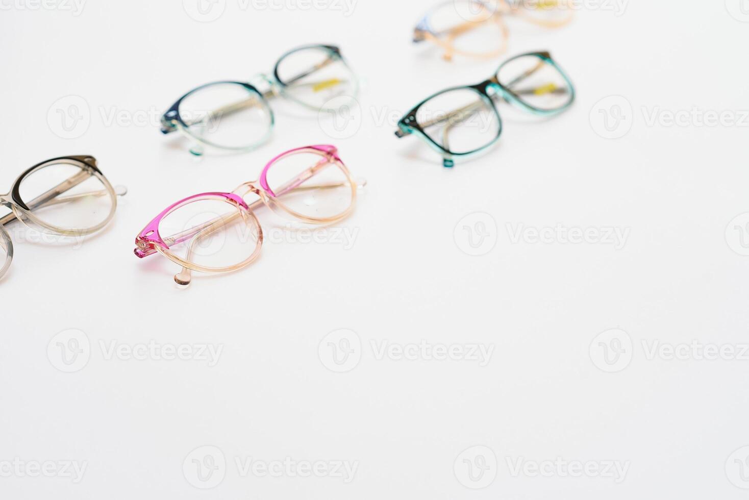 Stylish eyeglasses over background. Optical store, glasses selection, eye test, vision examination at optician, fashion accessories concept. Top view, flat lay photo