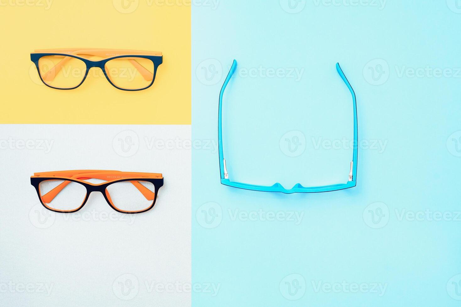 Stylish eyeglasses over background. Optical store, glasses selection, eye test, vision examination at optician, fashion accessories concept. Top view, flat lay photo