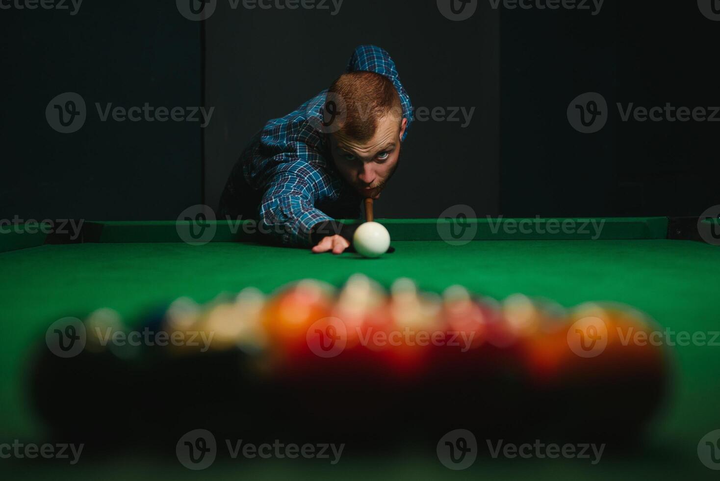 Man playing billiards in a club photo