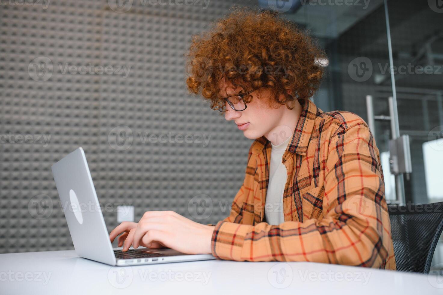 Stylish male freelancer working on new startup project making internet researchers analyzing data using laptop photo