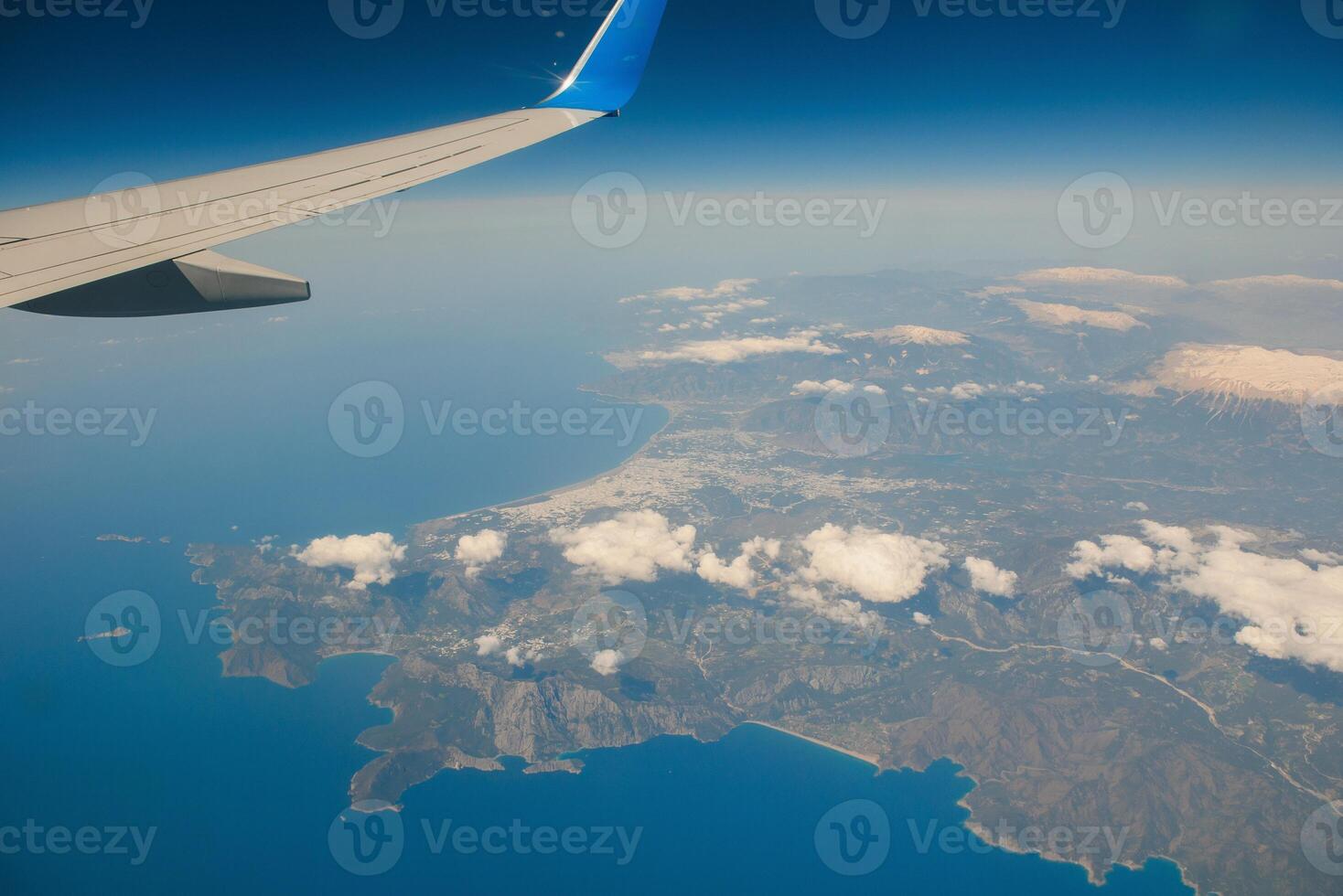 Clouds and sky as seen through window of an aircraft photo